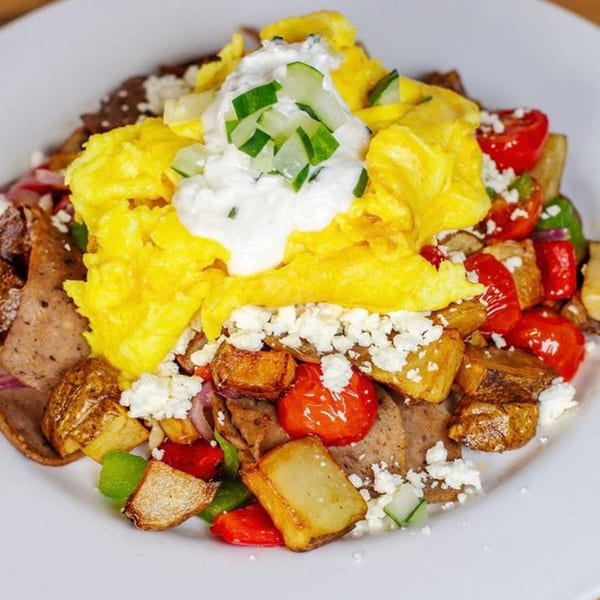 Honeybear Cafe's breakfast skillet with scrambled eggs, gyro meat, potatoes, peppers, feta, and tzatziki.