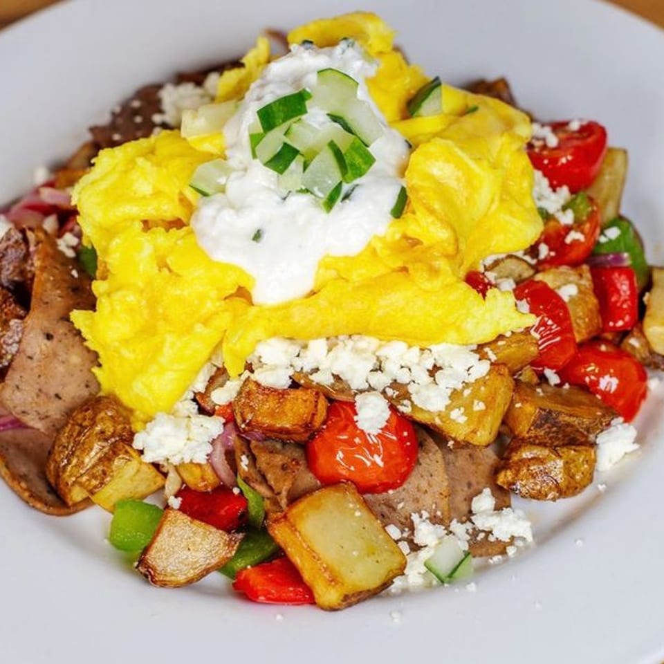 Honeybear Cafe's breakfast skillet with scrambled eggs, gyro meat, potatoes, peppers, feta, and tzatziki.