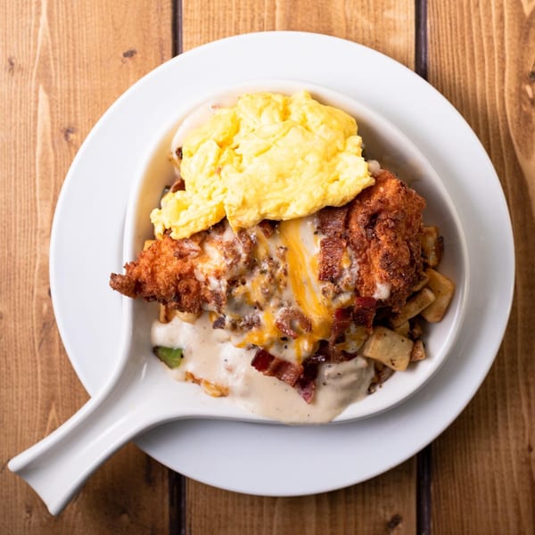 Honeybear Cafe's breakfast skillet with fried chicken, scrambled eggs, gravy, cheese, and bacon.